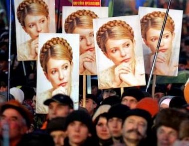 Ukrainian demonstrators hold a portraits of sacked Prime Minister Yulia Tymoshenko during a rally at the Indepedence Square in Kiev, November 22, 2005.