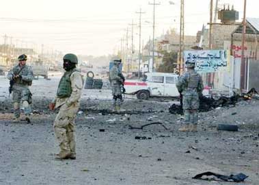 U.S. Army soldiers from the 101st Airborne Division inspect the site of a car bomb in Samara, Iraq Friday, Dec. 2, 2005, which caused no loss of life. In a separate incident ten U.S. Marines were killed and 11 wounded by a roadside bomb near Fallujah on Thursday, which was announced by the Marine Corps on Friday, in the deadliest attack on American troops in three months. (AP