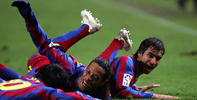 Barcelona's Deco of Portugal, Ronaldinho of Brazil and Gio from Holland (L to R) celebrate the first goal against Espanyol during their Spanish Primera Liga soccer match in Barcelona January 7, 2006.